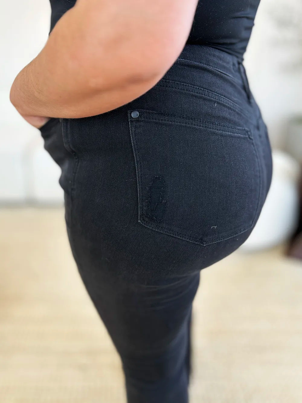 Side view of Judy Blue high-waist distressed flare jeans on a model.