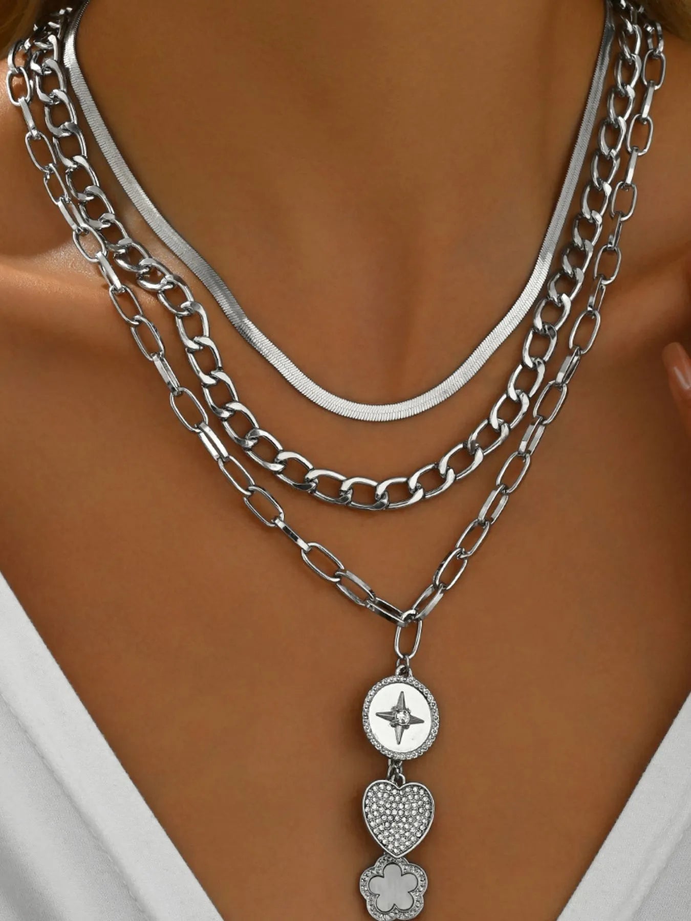 Layered 18K gold-plated stainless steel necklace with heart and flower charms.