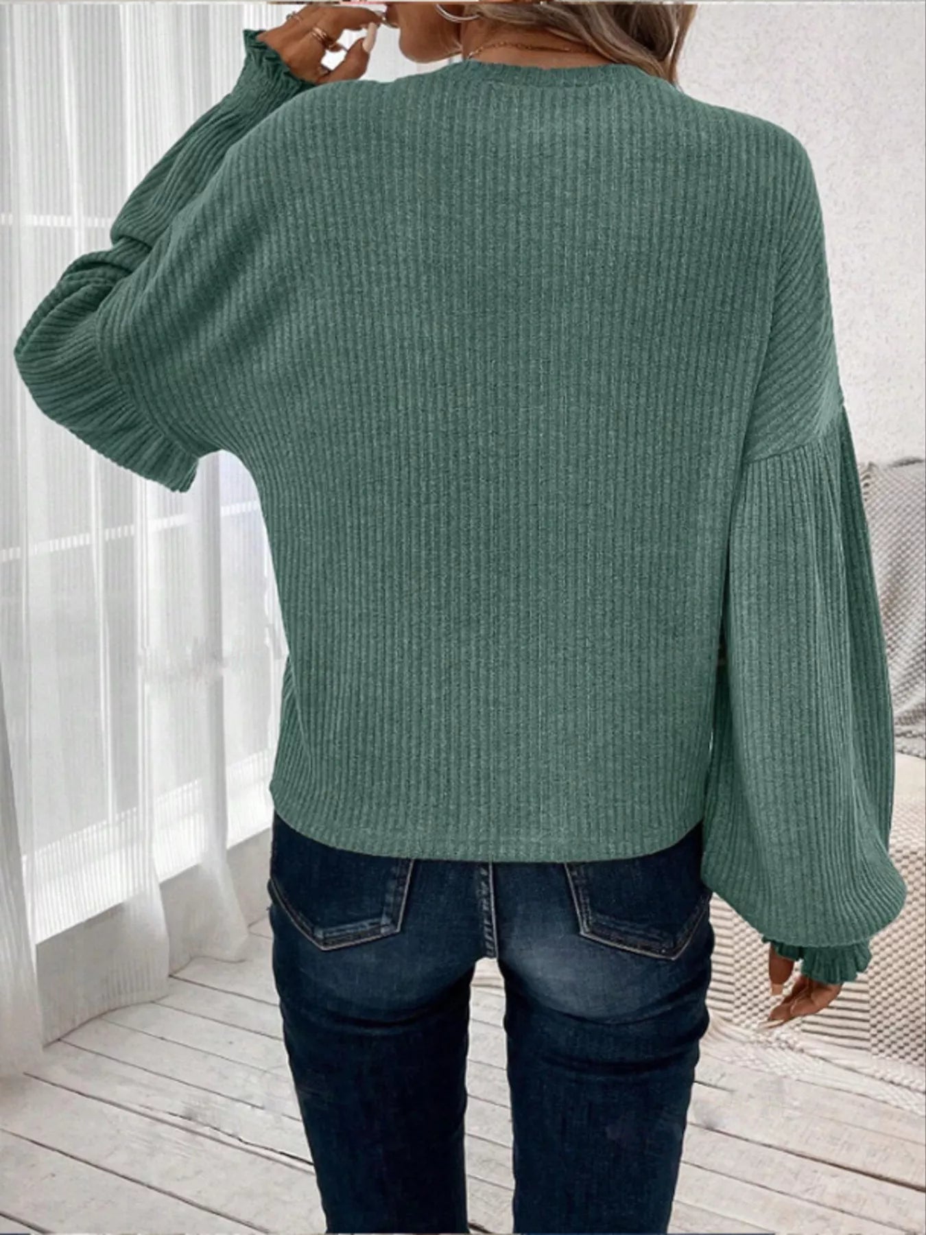 Ribbed long sleeve t-shirt made of a stretchy polyester blend in various sizes.