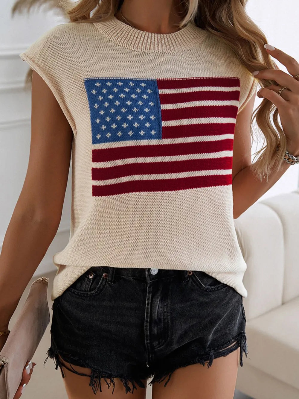 Red, white, and blue US flag sweater vest with a round neck and moderate stretch.