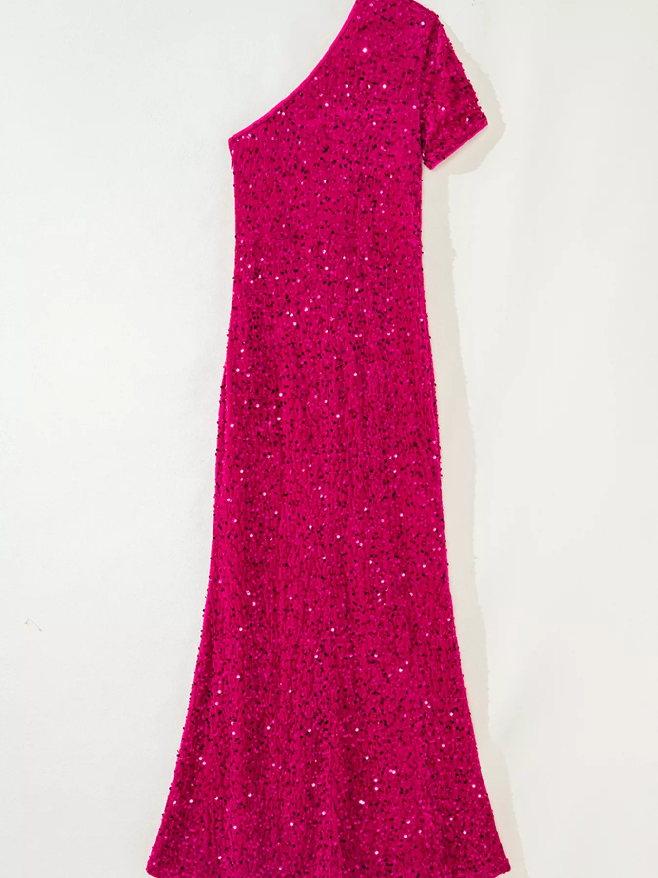 One-shoulder sequin dress in cotton spandex blend with a high slit for a stylish silhouette.