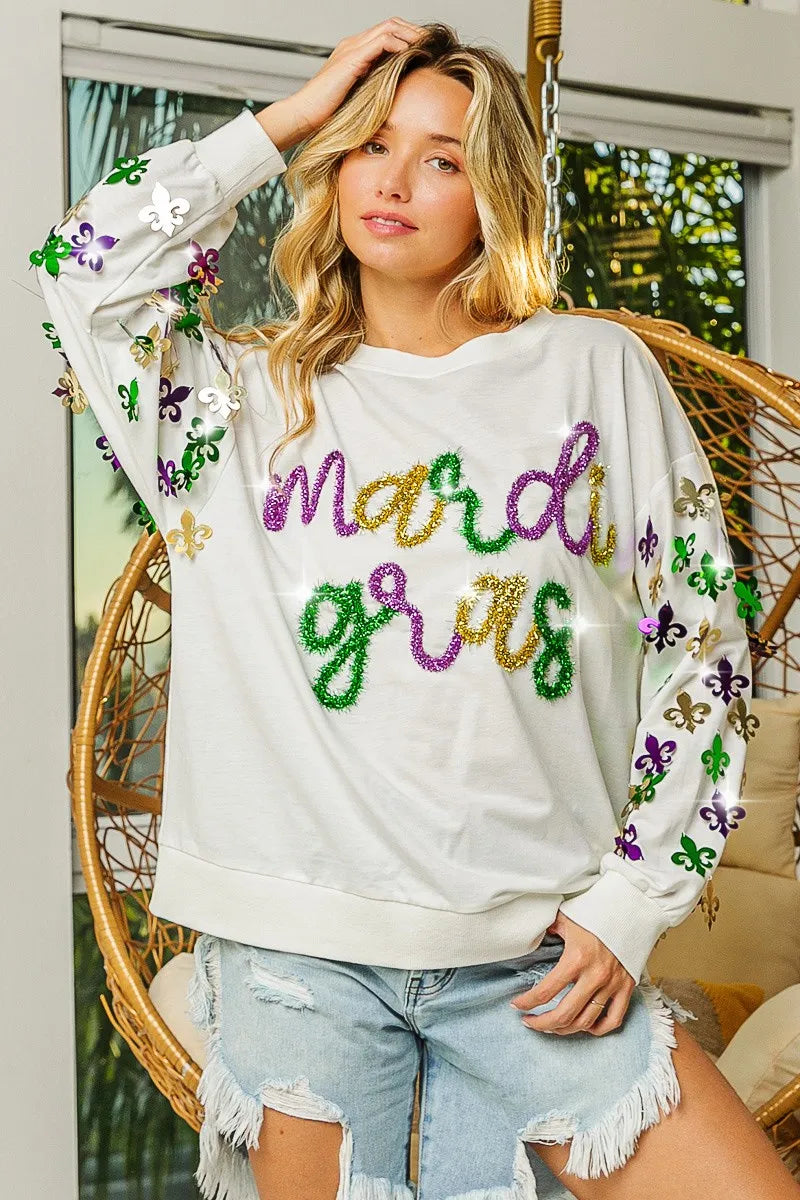 Pullover with Fleur De Lis designs on sleeves in soft fabric for Mardi Gras casual wear