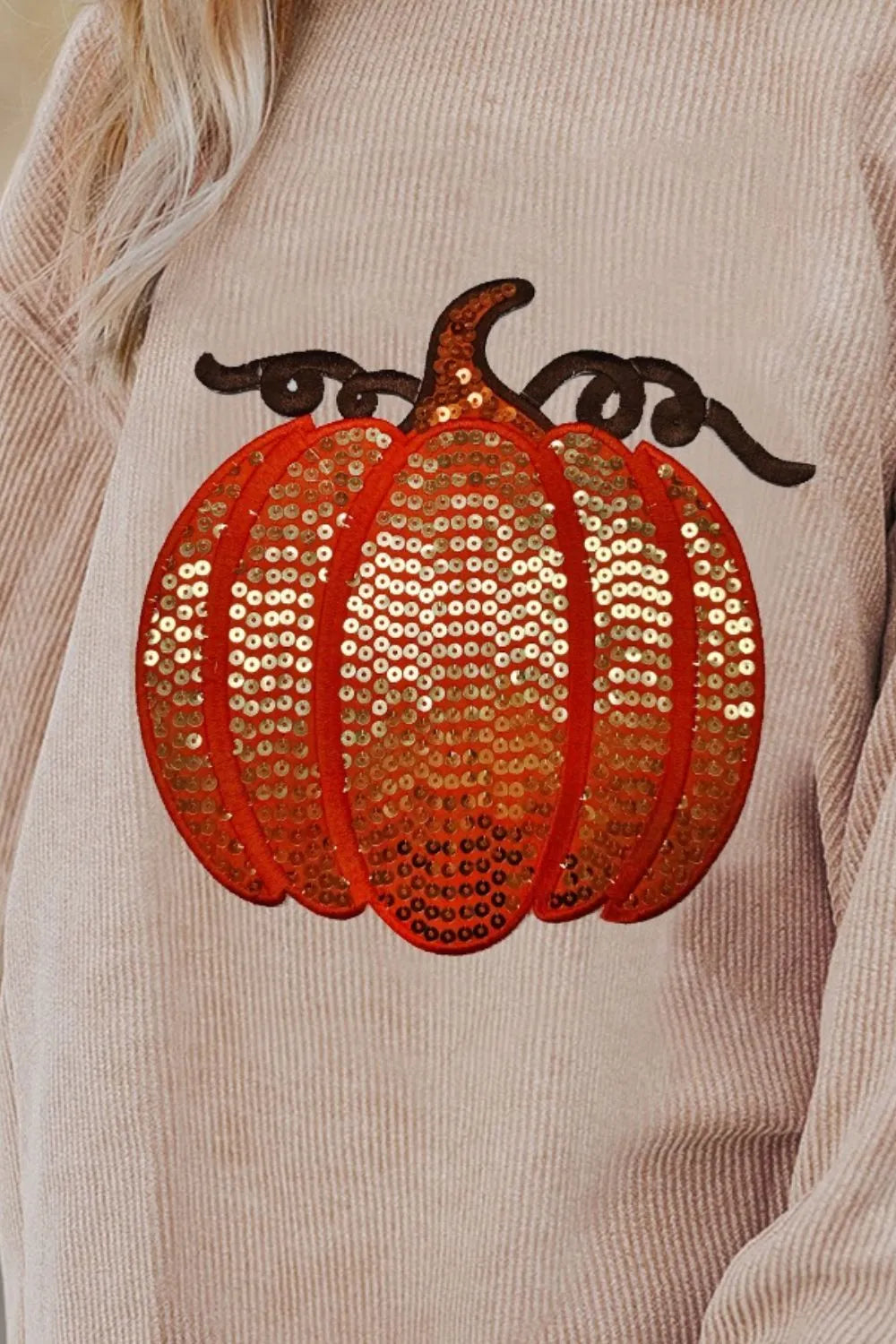 Long sleeve round neck sweatshirt featuring a sequin pumpkin design on a cozy fabric.