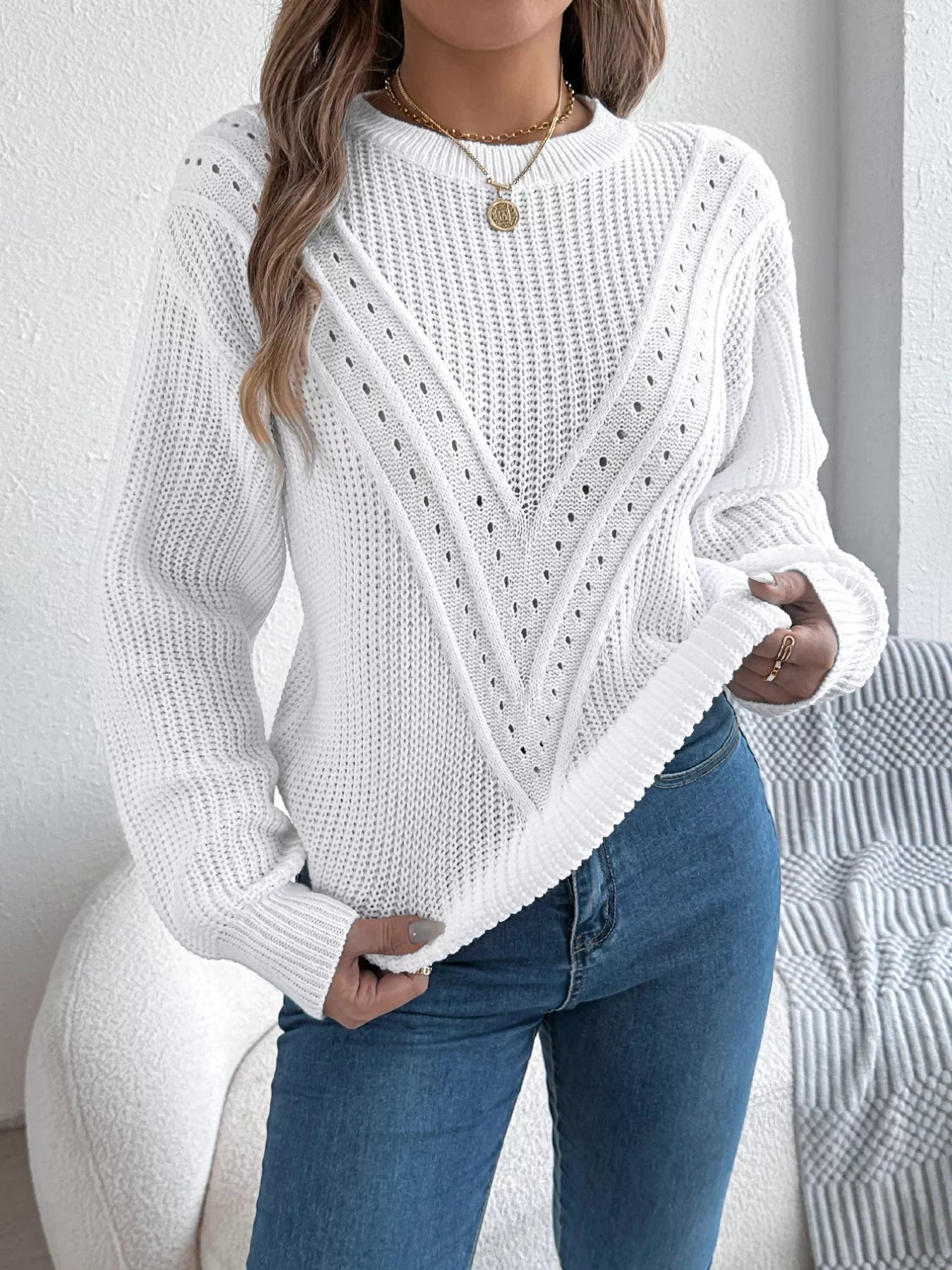 Openwork acrylic sweater with a round neck and slightly stretchy, breathable fabric.