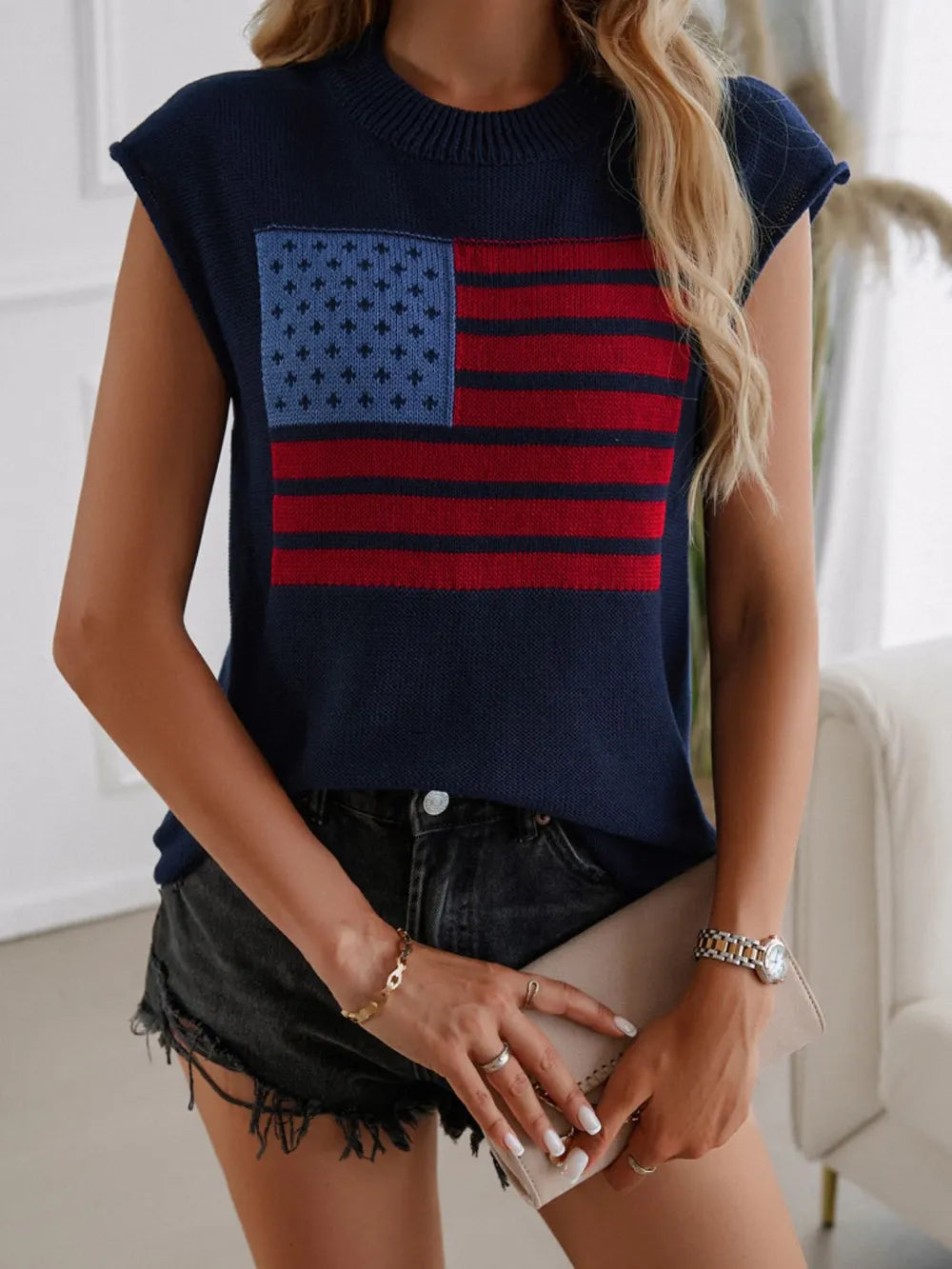 Red, white, and blue US flag sweater vest with round neck and moderate stretch.