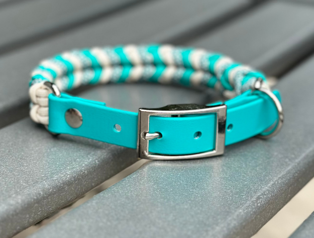 Teal and cream diamond-pattern hand-braided dog collar with adjustable BioThane strap and nickel buckle.