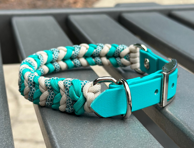 Hand-braided teal and cream diamond pattern dog collar with adjustable teal strap and D-ring.