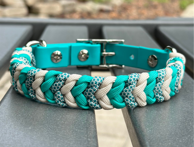 Hand-braided teal and cream diamond-pattern dog collar with adjustable buckle.