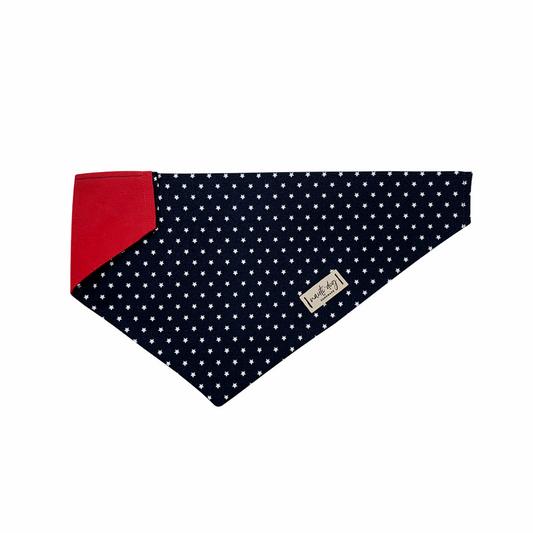 Navy dog bandana with white stars and red corner, fits over collar.