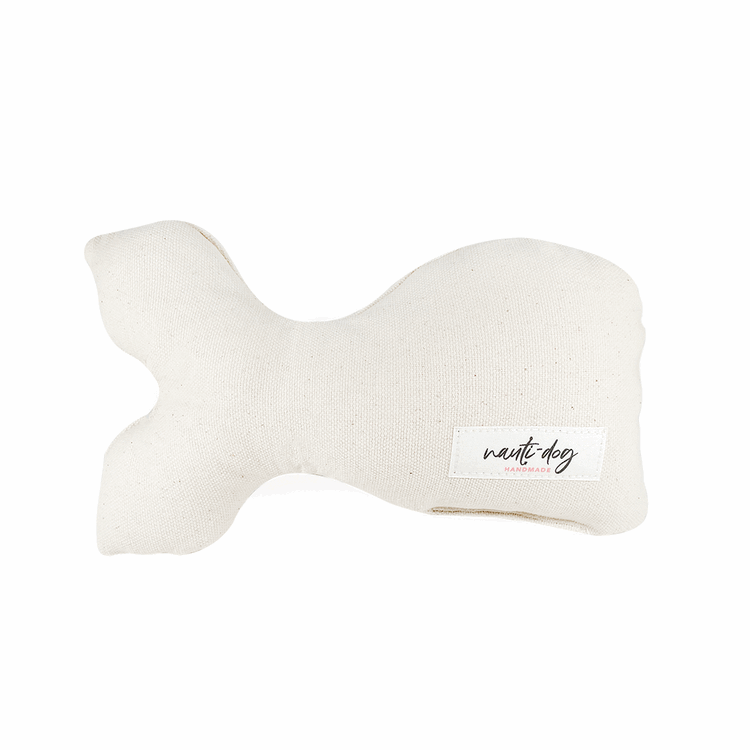 Ivory canvas stuffed whale dog toy with squeaker and "Nest Dog" label.