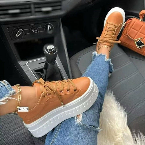 Tan leather platform sneakers for women with white sole and laces.