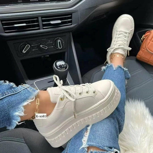 Tan leather platform sneakers for women with lace-up front and thick sole.