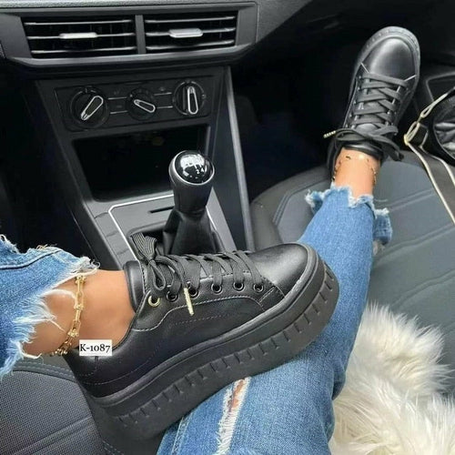 Tan leather platform sneakers for women with lace-up front and thick sole.