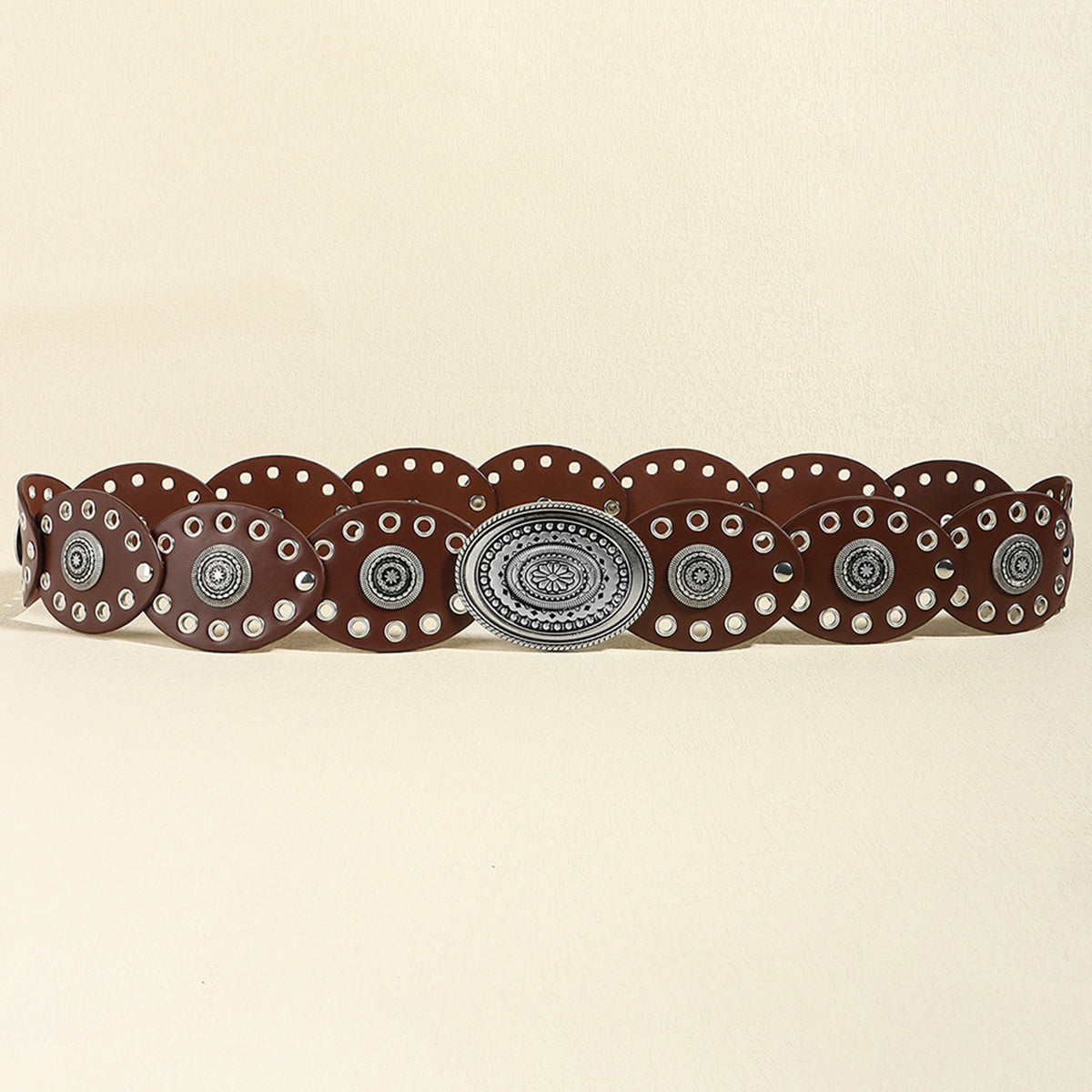 Brown PU leather belt with oval silver buckle and circular stud details.