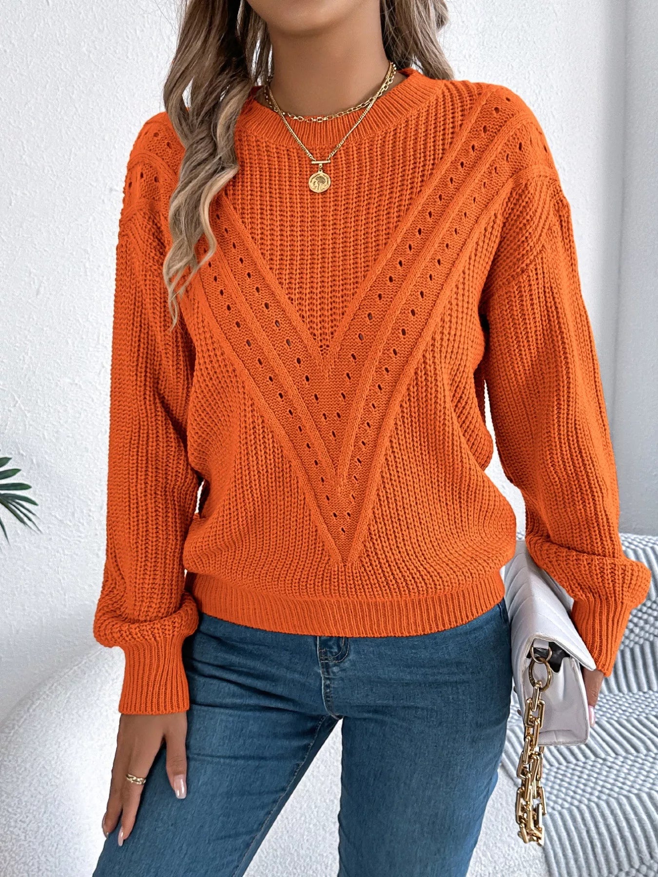 Lightweight acrylic sweater with openwork knit, round neck, and slight stretch for comfort