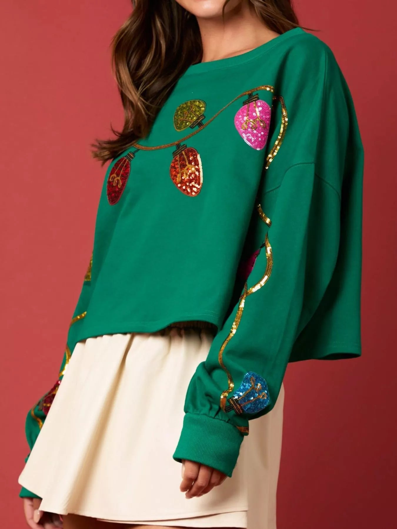 A cozy sweatshirt featuring shimmering sequin embellishments in a relaxed fit.