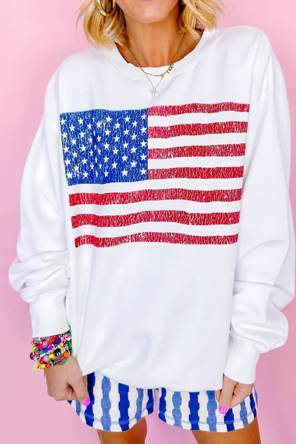 Long sleeve sweatshirt with US flag design, round neck, and slightly stretchy cotton blend.