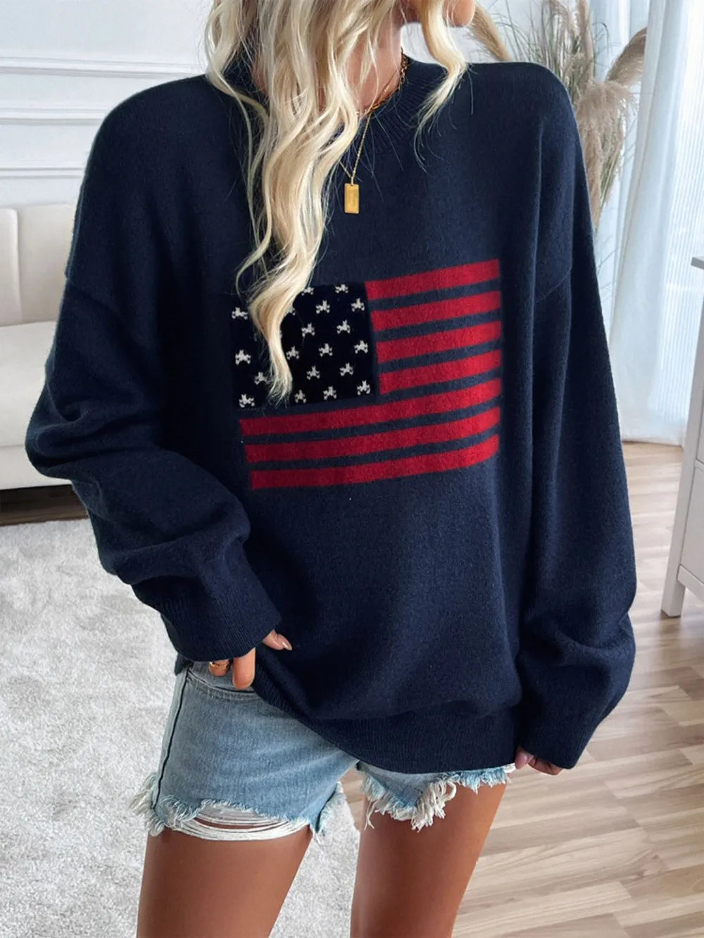 Round neck long sleeve knit top featuring the US flag design in an acrylic blend.