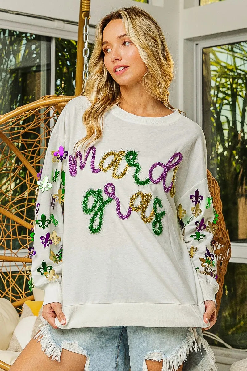 Pullover with Fleur De Lis designs on sleeves in soft fabric for Mardi Gras casual wear