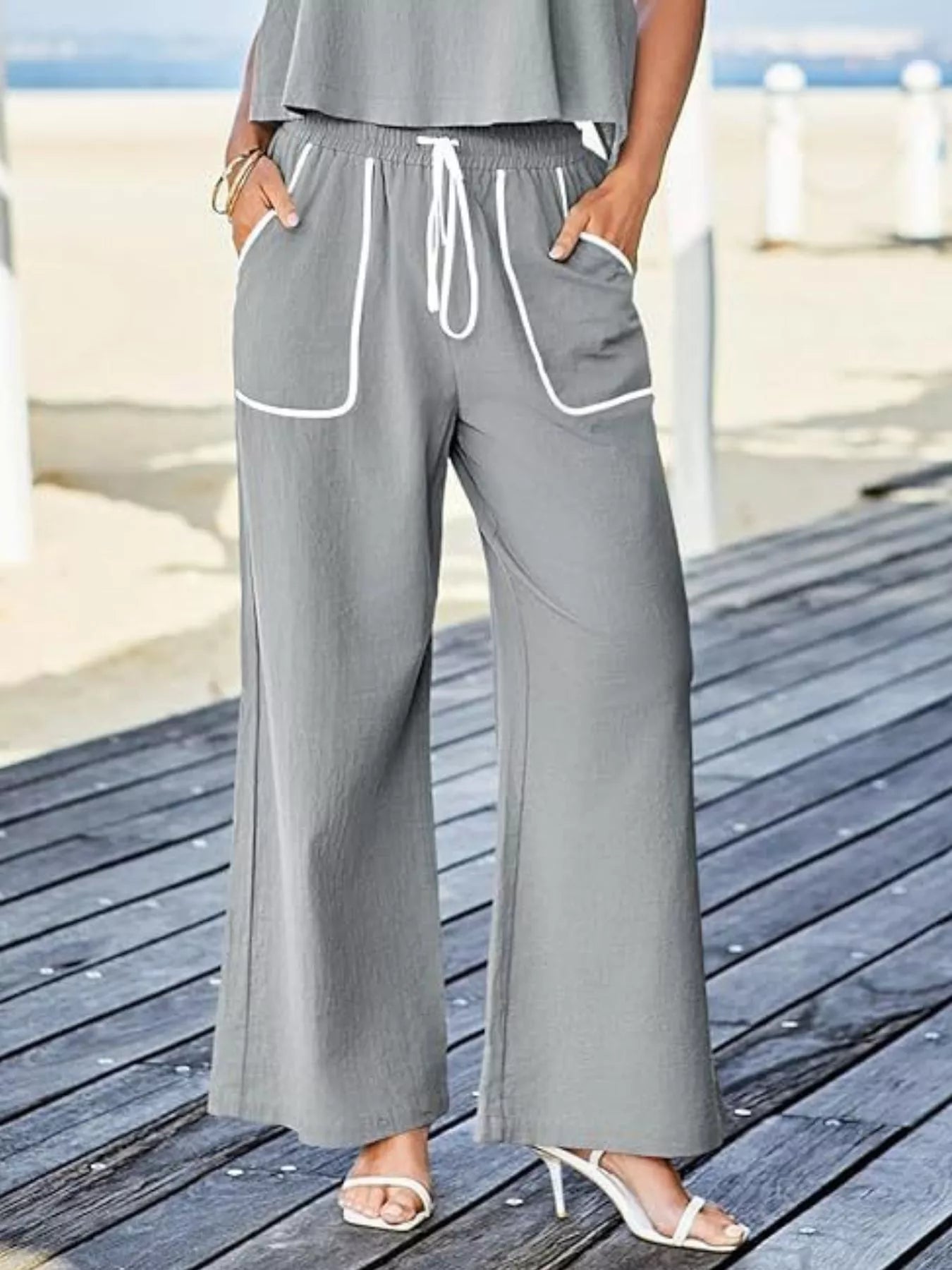 Two-piece tank and pants set with contrast trim, drawstring, and pockets.