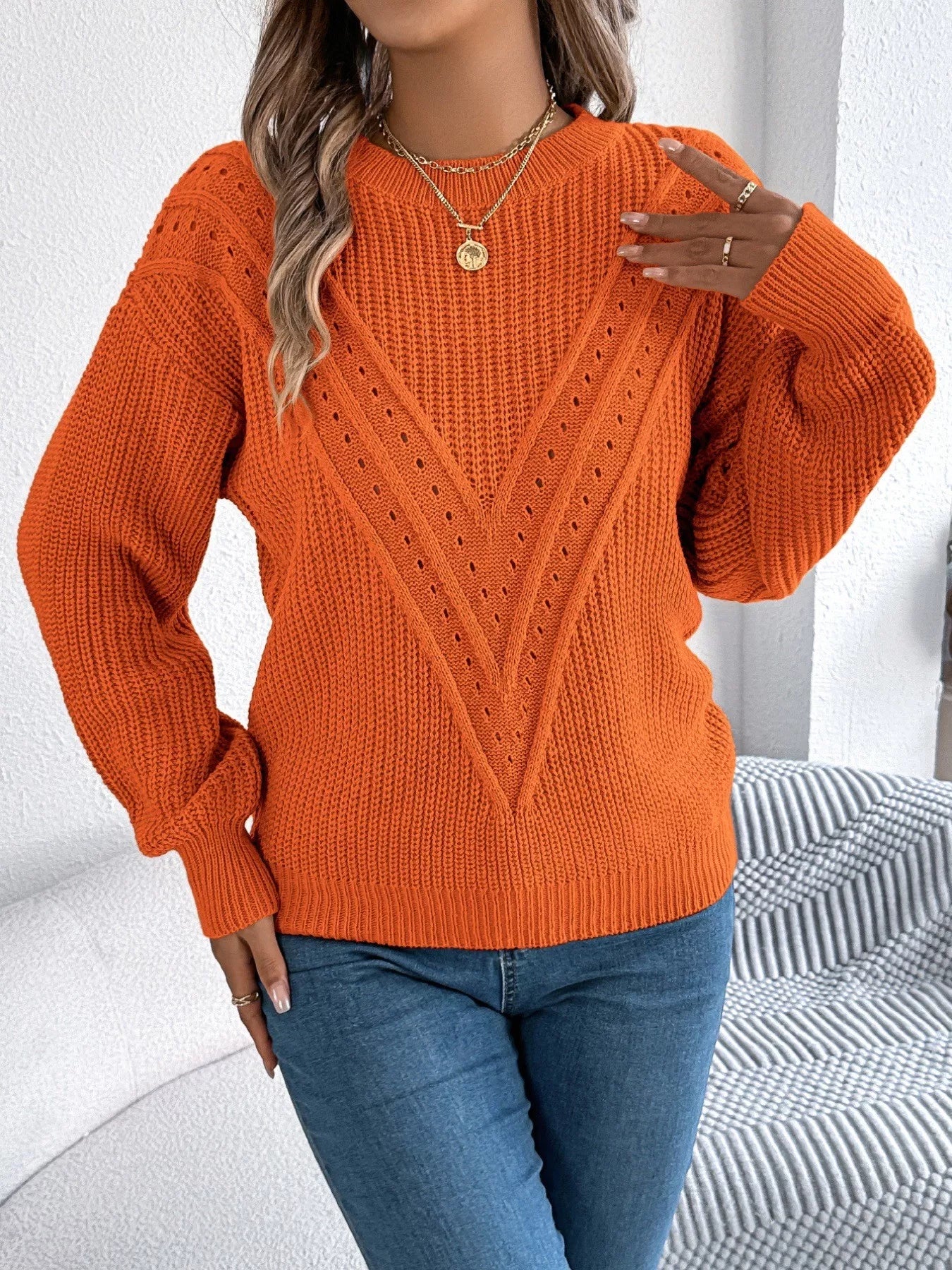 Openwork acrylic sweater with a round neck and slightly stretchy, breathable knit design.