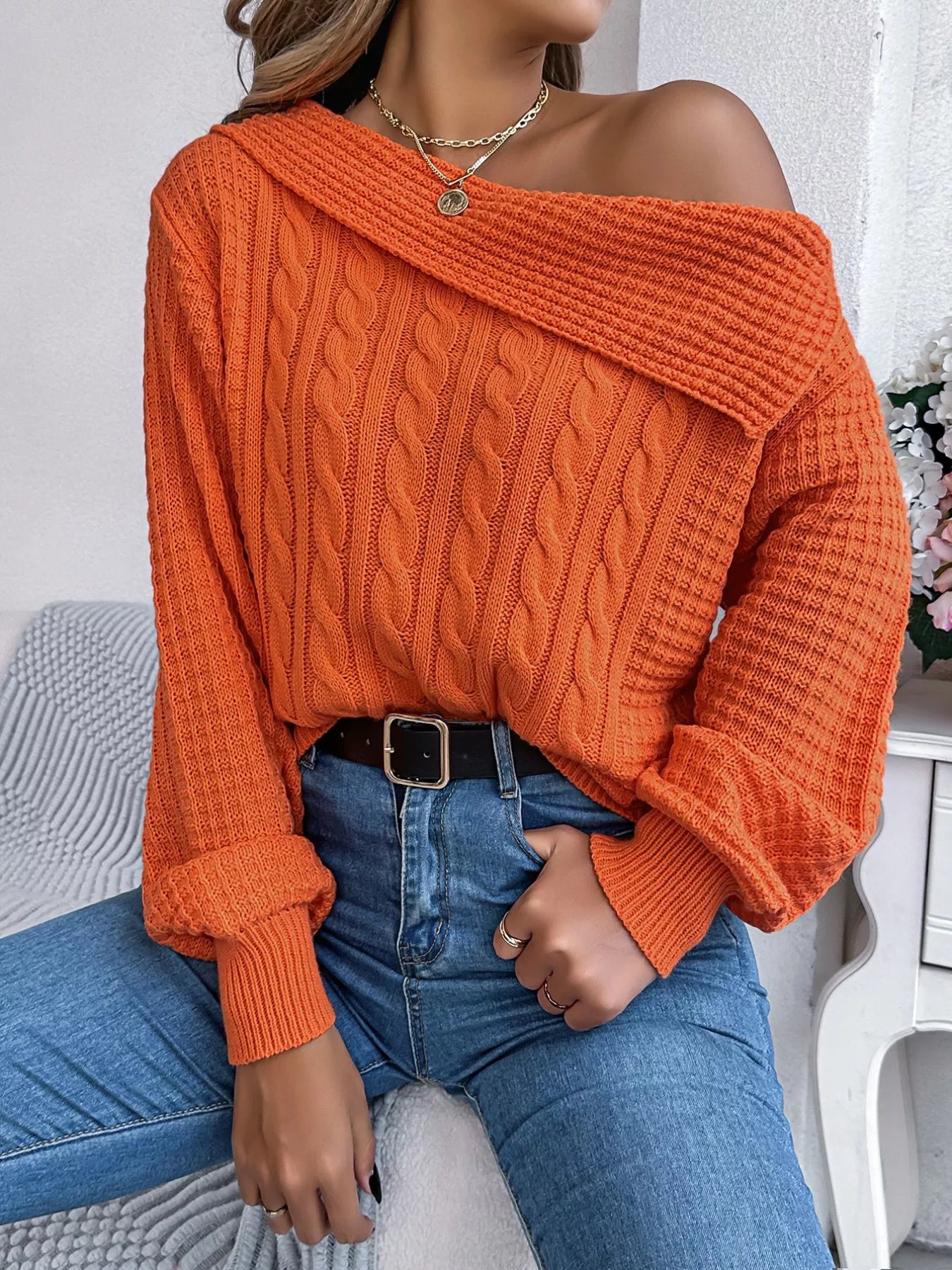 Off-shoulder cable knit sweater in soft acrylic with slight stretch and classic texture