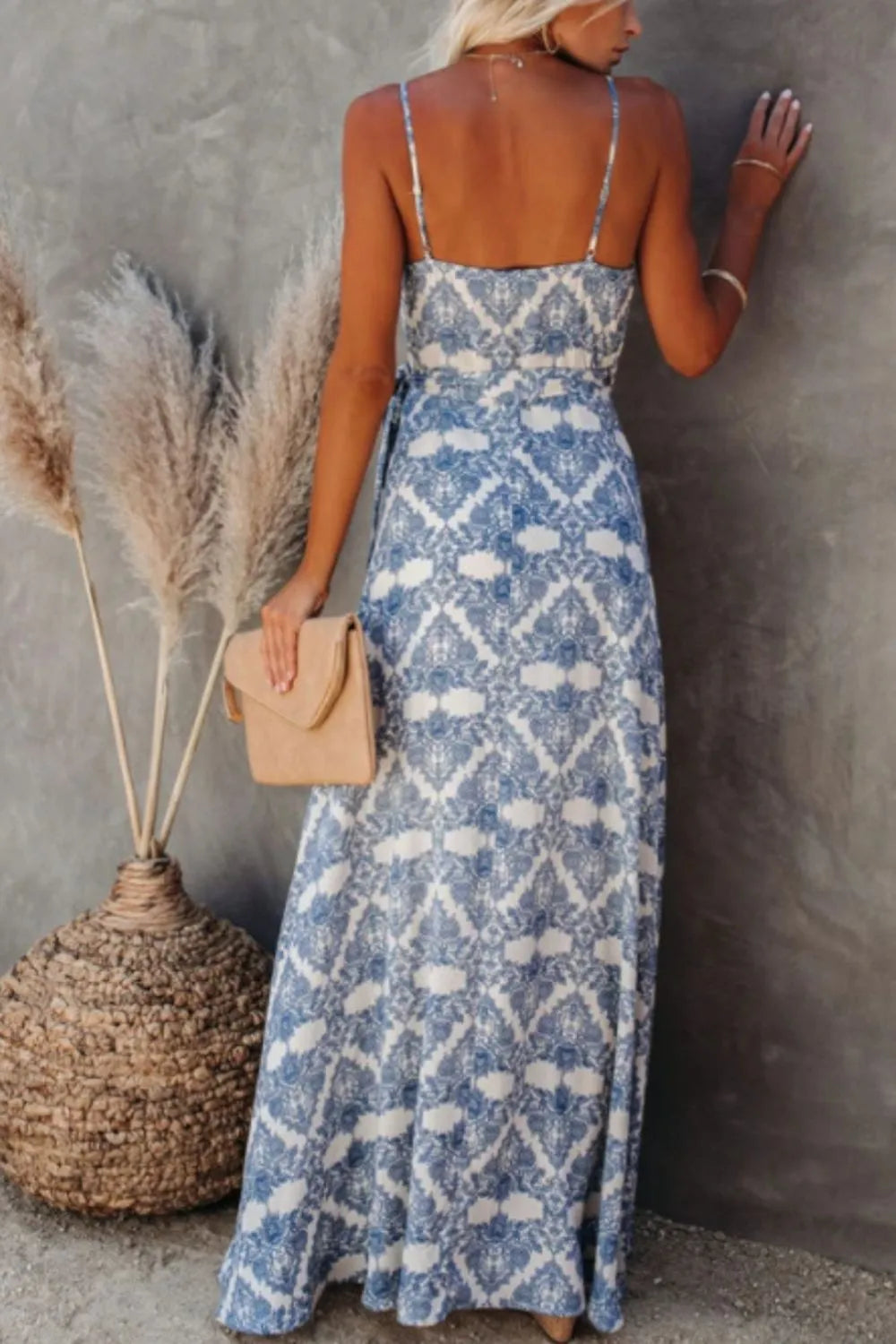 Back view of a blue ikat printed tied maxi cami dress on a model.