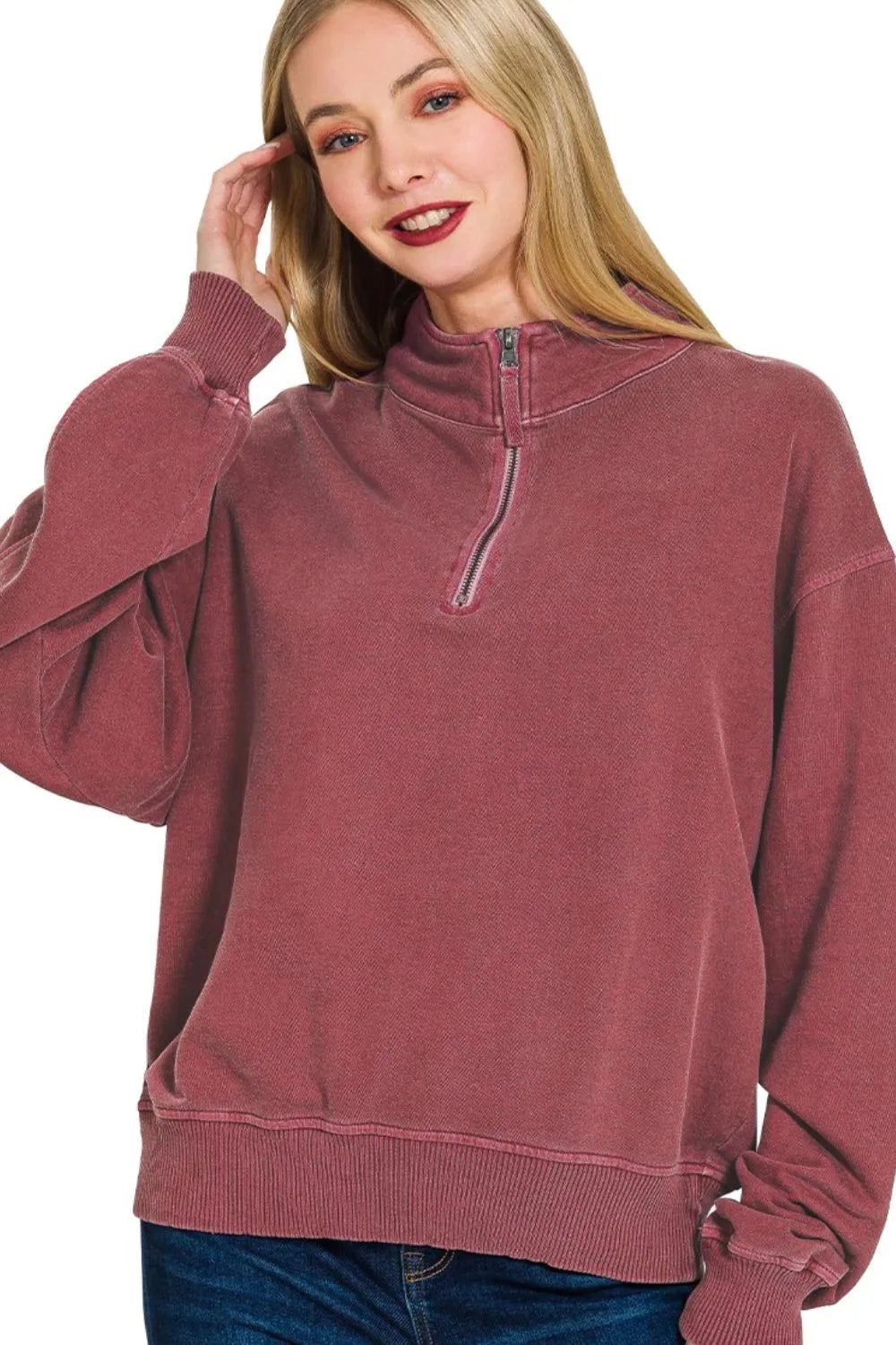 Woman modeling a dusty rose quarter-zip cotton fleece pullover with relaxed fit.