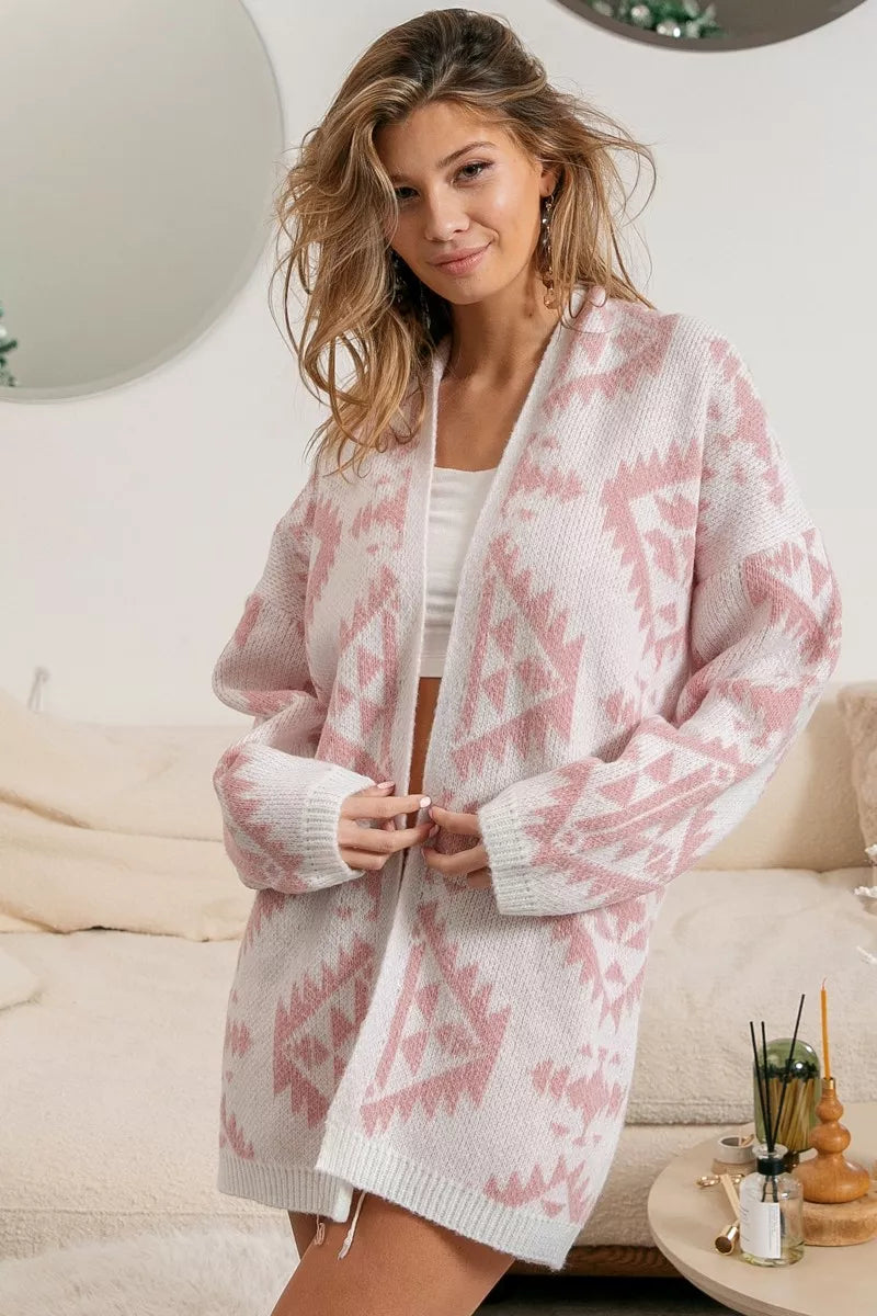 Pink open-front acrylic cardigan with Aztec pattern, modeled on a woman.
