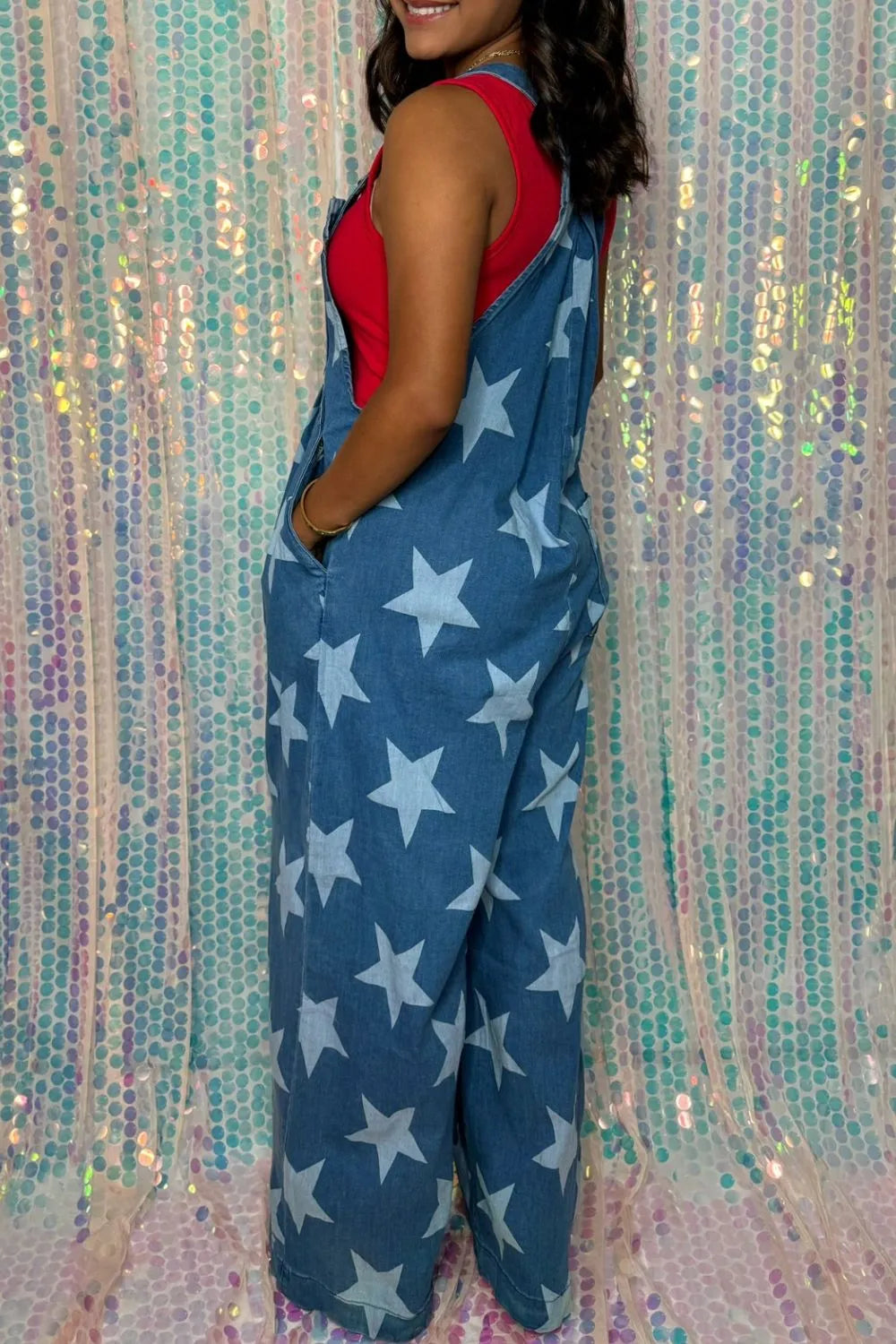Wide leg denim overalls with star print and front pockets in a cotton blend fabric.