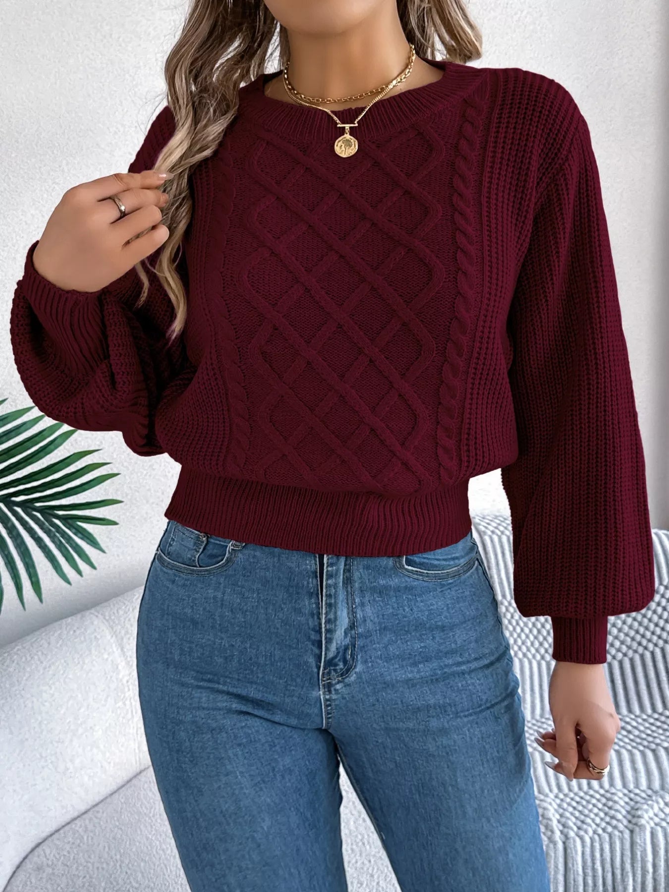 Long sleeve acrylic sweater with cable knit diamond pattern in neutral color