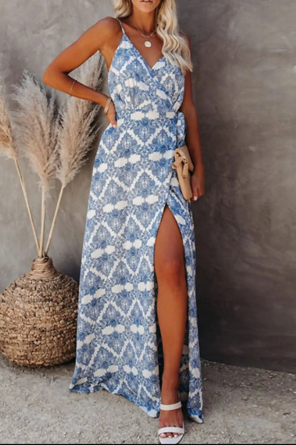 Blue ikat printed tied maxi cami dress on model with pampas grass backdrop.