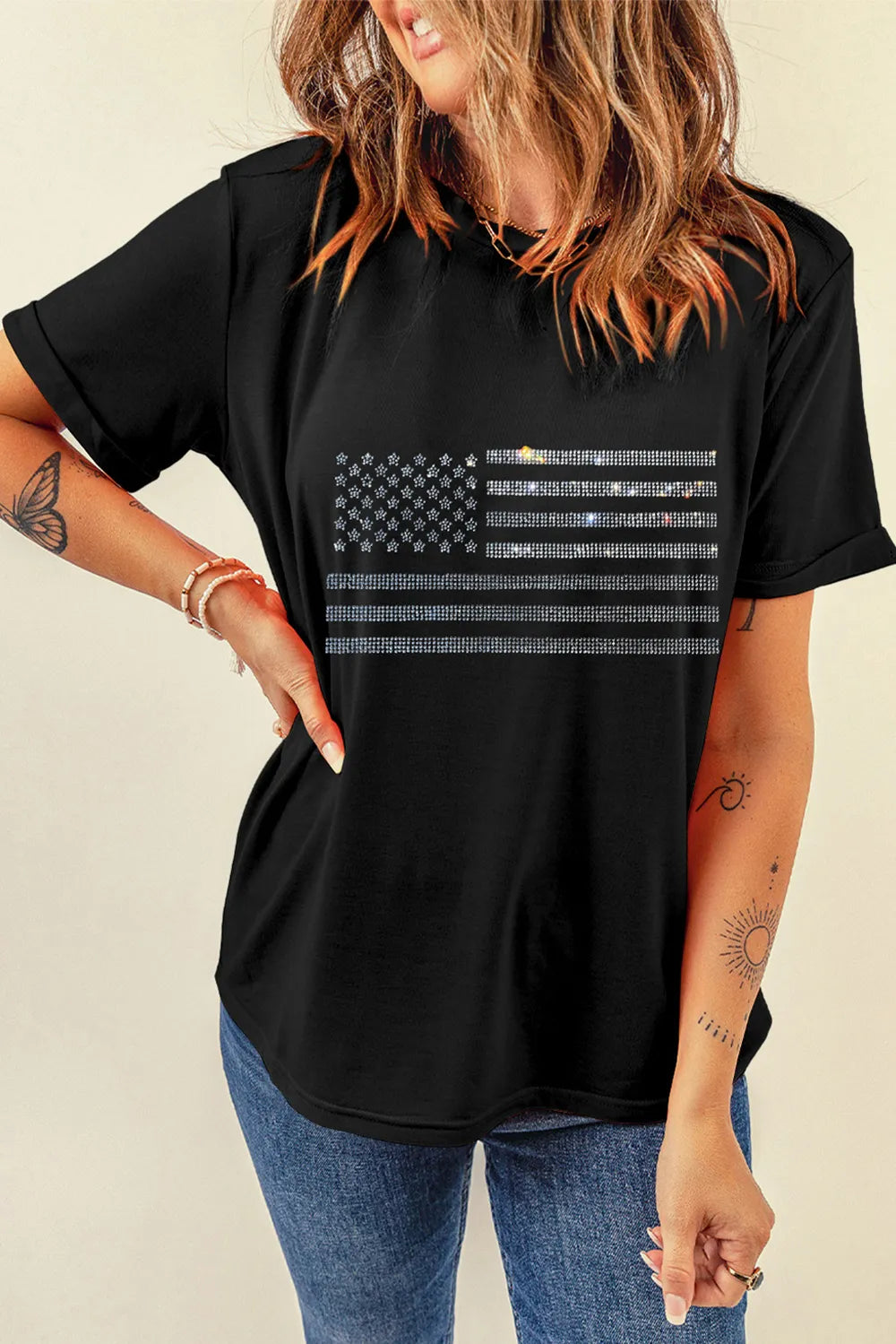 Short sleeve t-shirt featuring a rhinestone US flag design on a stretch cotton blend fabric.