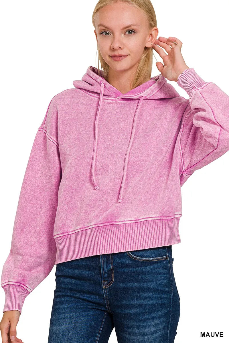 Zenana acid wash fleece drawstring cropped hoodie in pink, modeled on a woman.