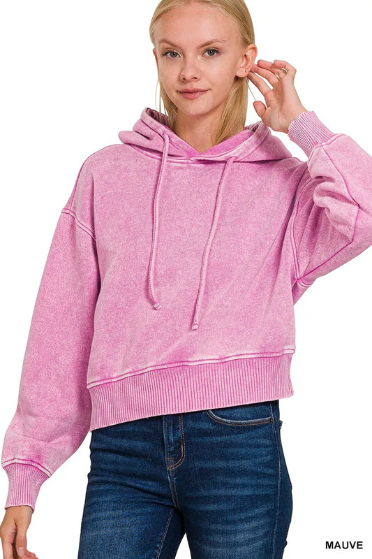 Zenana acid wash fleece drawstring cropped hoodie in pink, modeled on a woman.