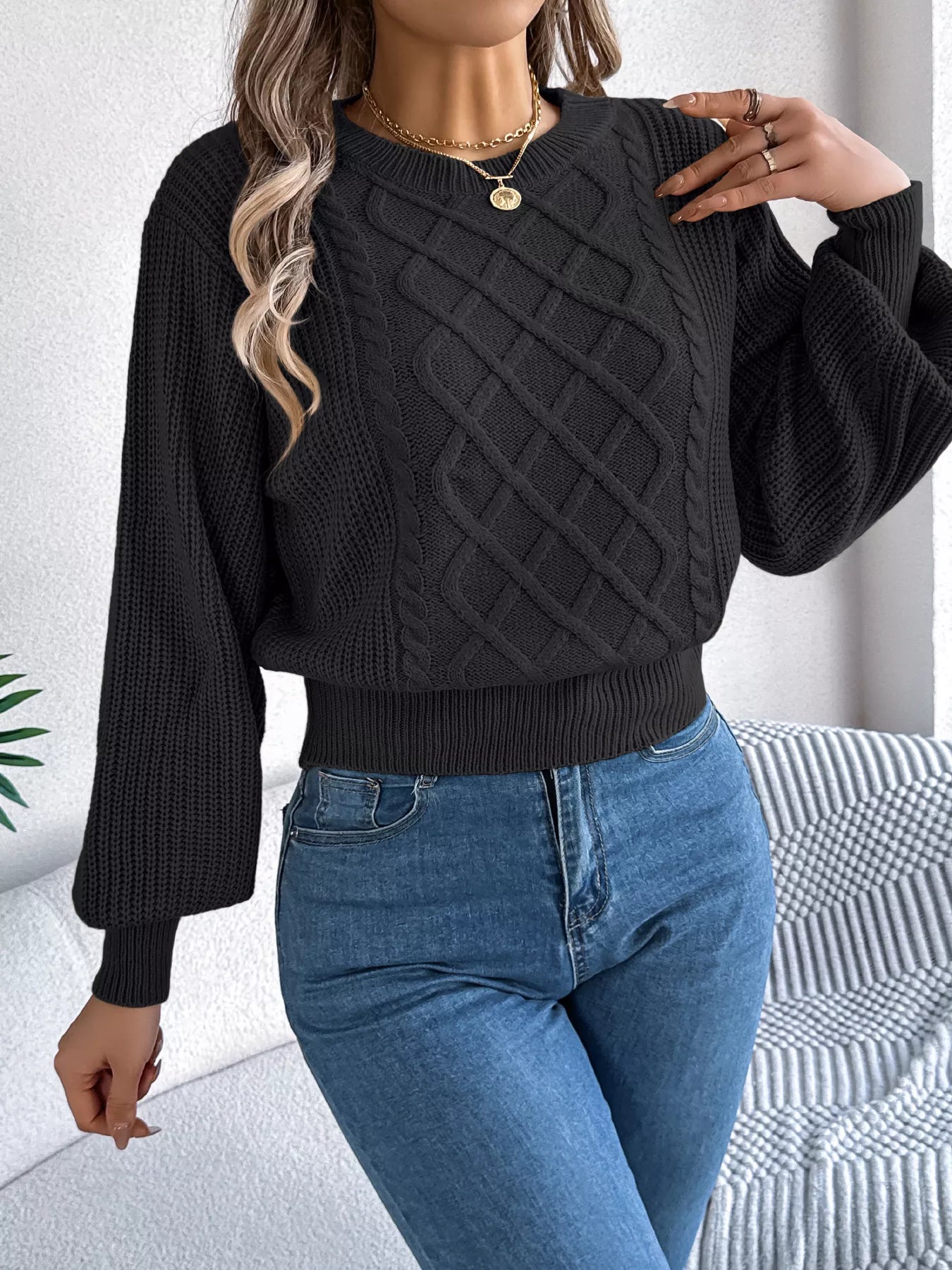 A long sleeve acrylic sweater featuring a cable knit diamond pattern in a cozy fit.