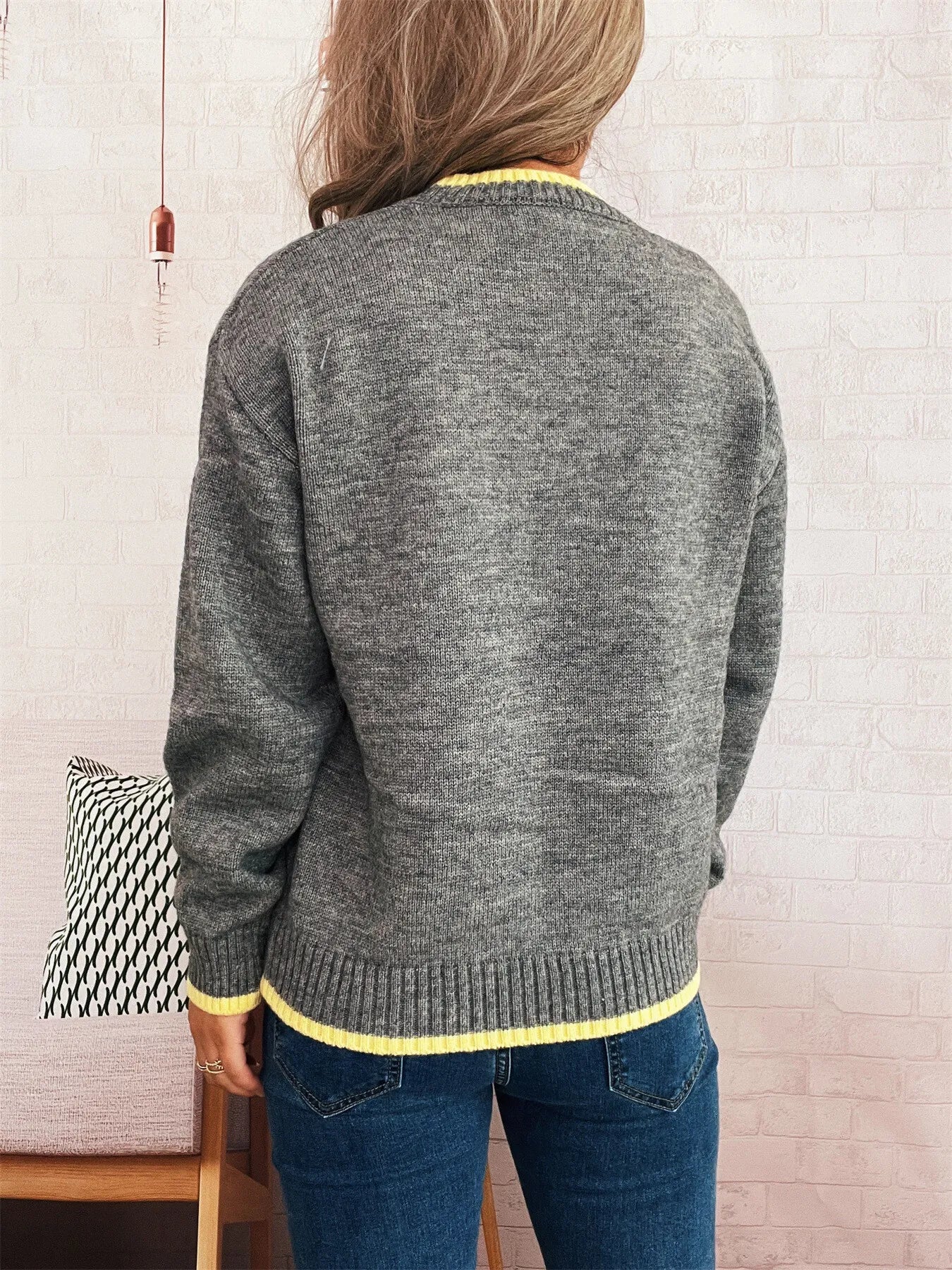 A ribbed long sleeve sweater with contrast trim, made of 100% polyester.