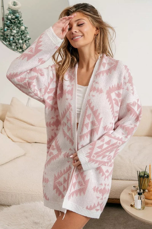 Pink open-front acrylic cardigan with Aztec pattern, modeled on a smiling woman.