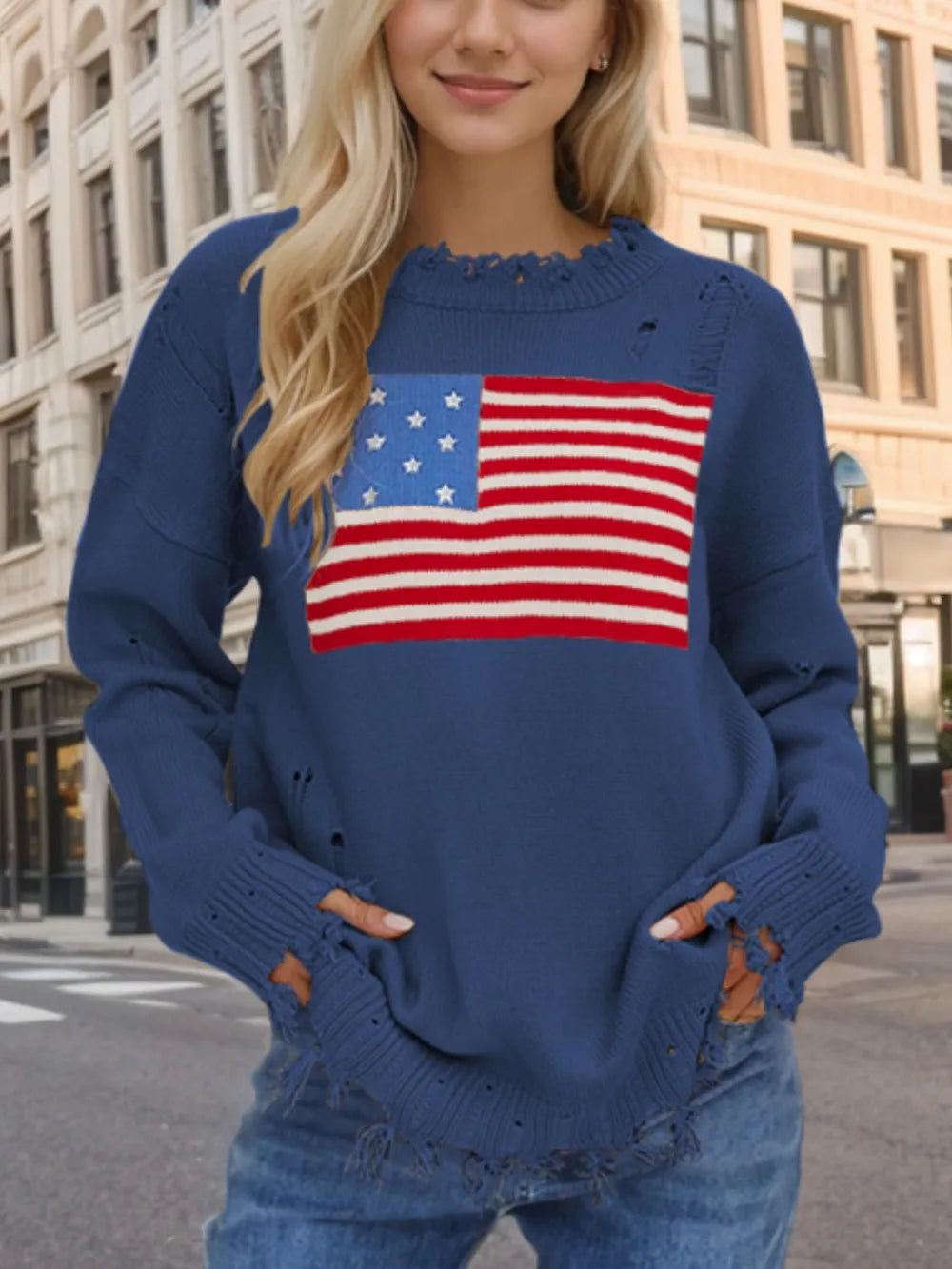 Distressed acrylic sweater with US flag design, round neck, and long sleeves.