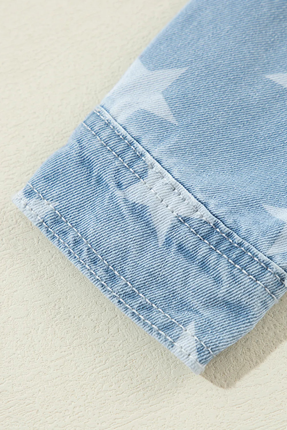 Denim top with raw hem and star collar made from cotton blend fabric.