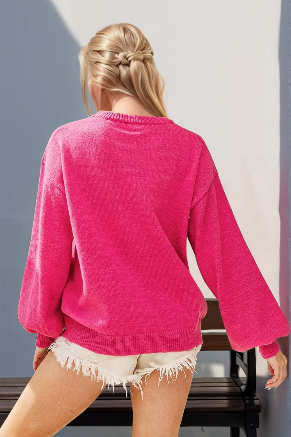 Back view of a long-sleeve blush sequin nutcracker sweater on a model.