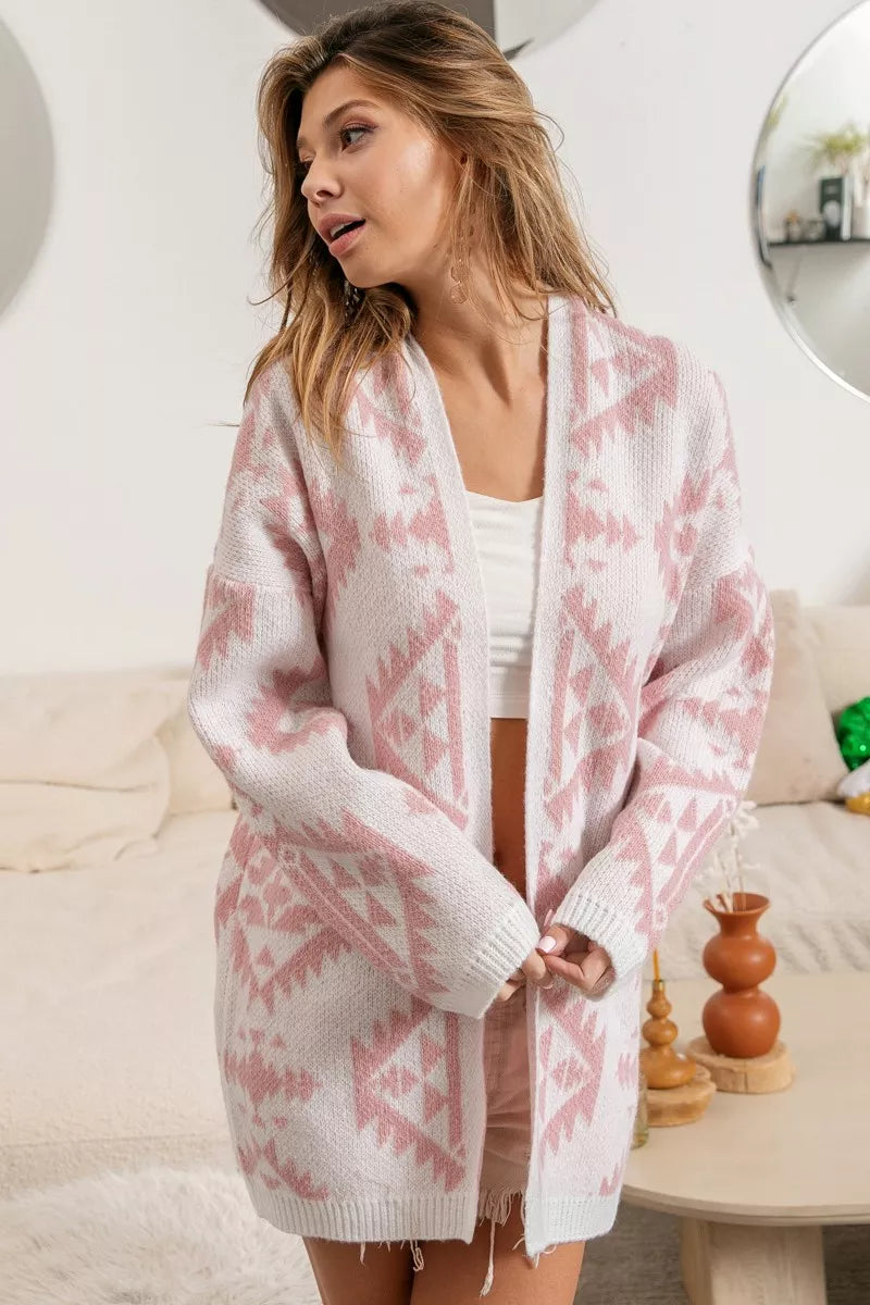 Pink open-front acrylic cardigan with Aztec pattern, modeled on a woman.