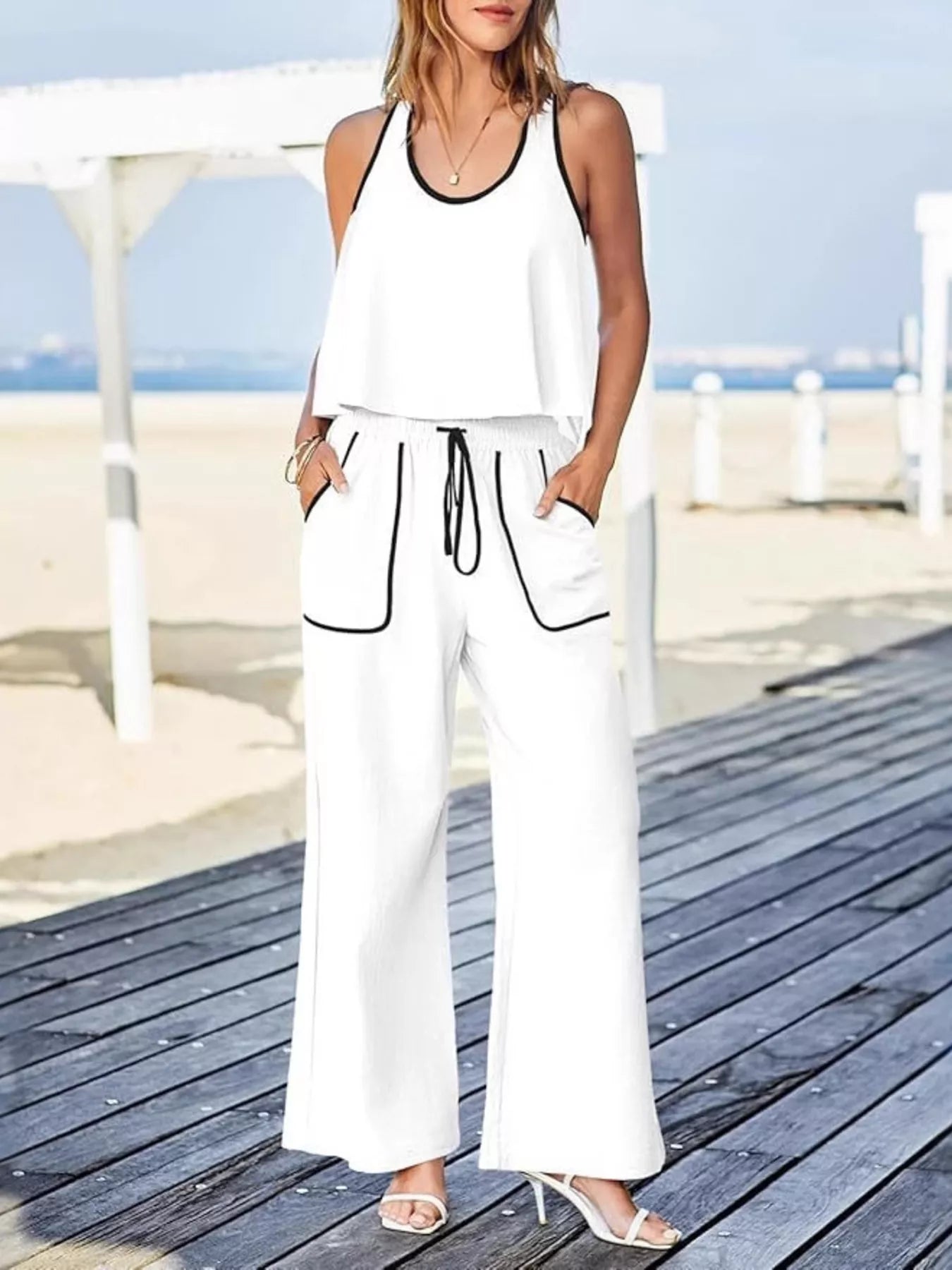 Two-piece tank and pants set in polyester and spandex with drawstring and pockets.