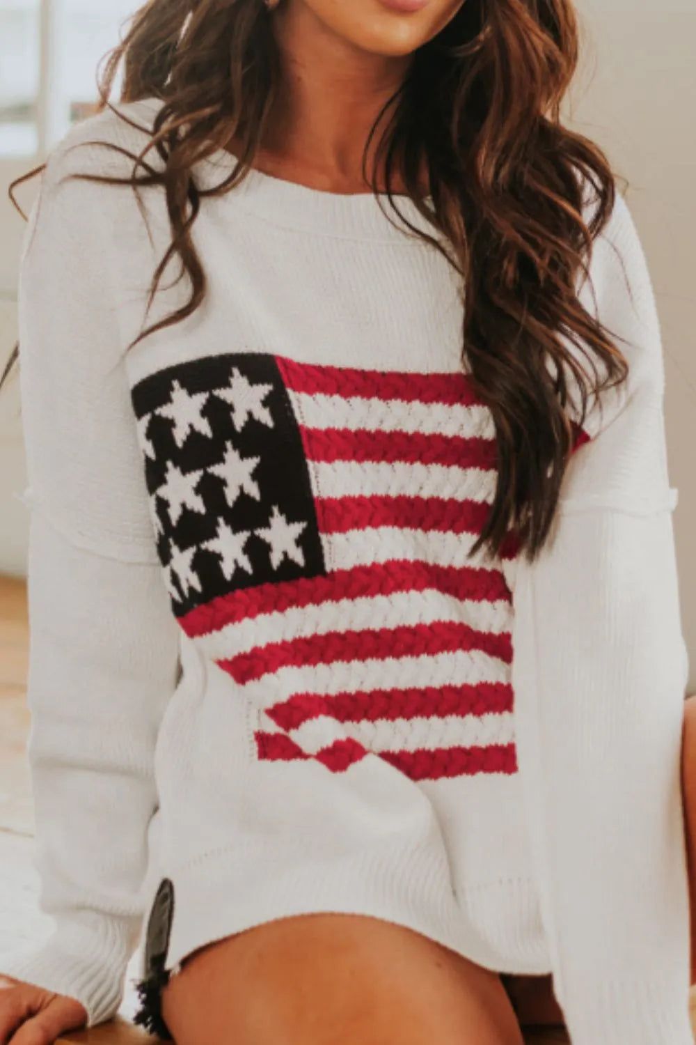 US flag patterned sweater with side slits and drop shoulders in a soft acrylic-cotton blend.