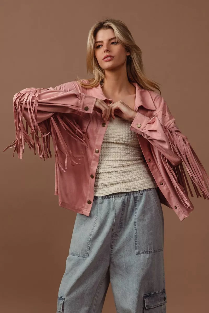 BiBi suede fringe long sleeve jacket in pink, model wearing with gray pants.