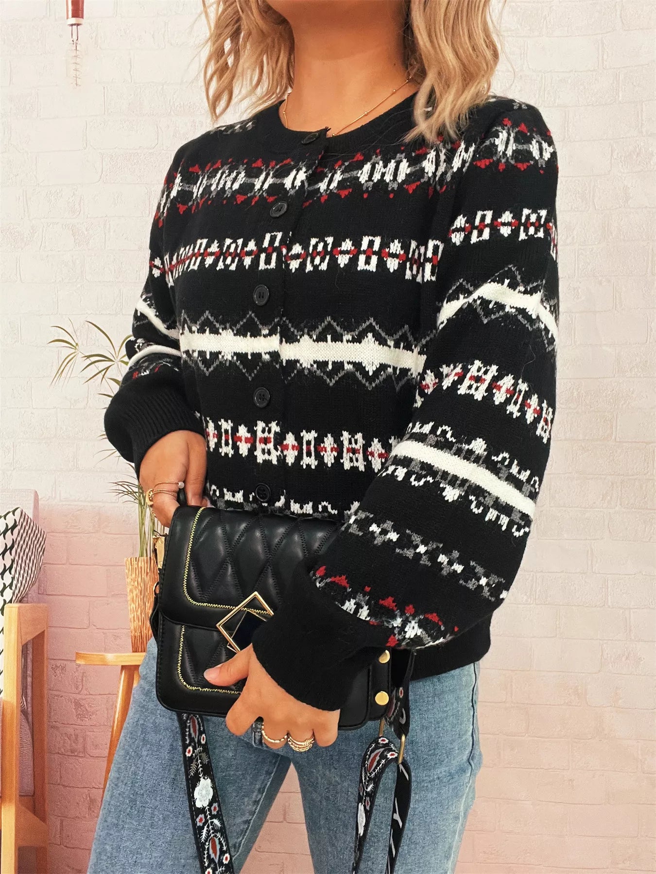 A vintage pattern button-down cardigan made of 100% polyester with a slightly stretchy fit.