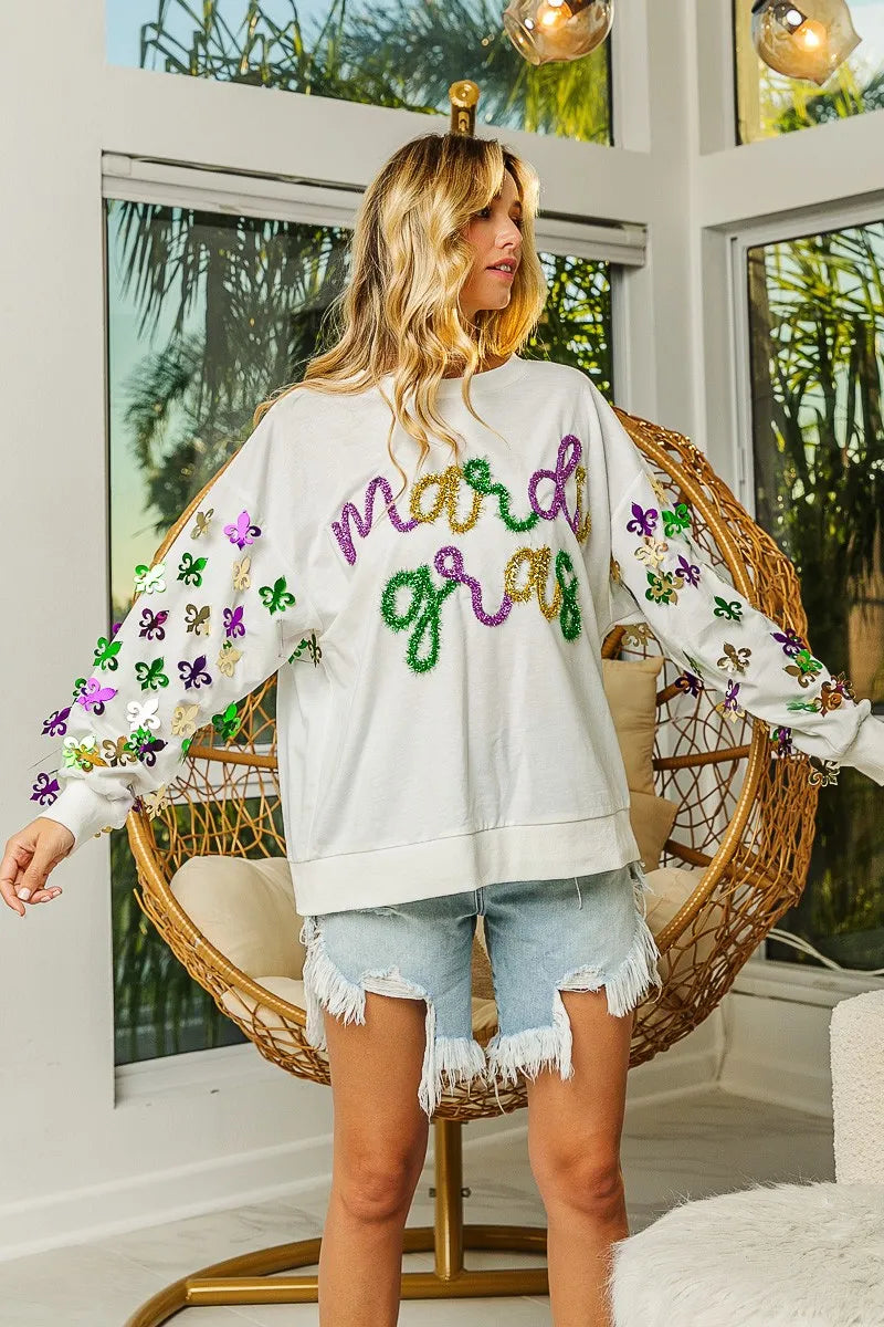 Pullover with Fleur De Lis designs on sleeves in soft fabric for casual Mardi Gras wear
