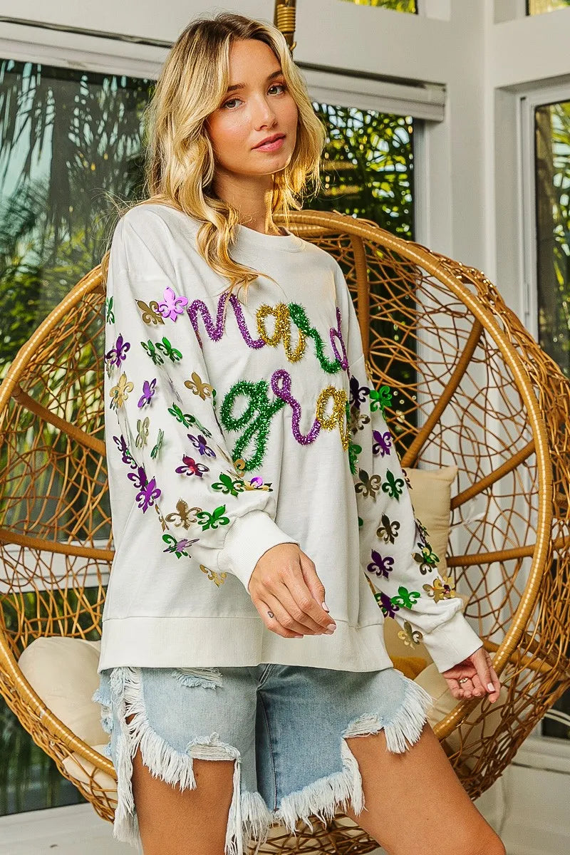 Pullover with Fleur De Lis designs on sleeves in soft fabric for Mardi Gras casual wear
