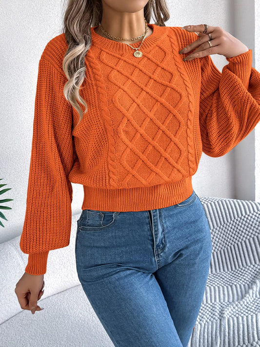 A long sleeve acrylic sweater featuring a cable knit diamond pattern in a cozy fit.