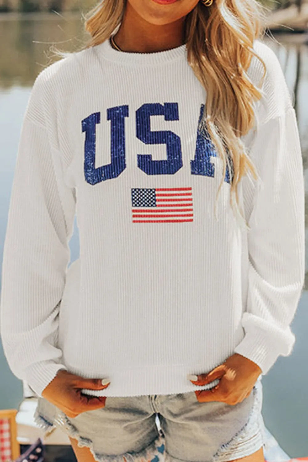 Long sleeve sweatshirt with US flag design in polyester blend fabric and slight stretch.